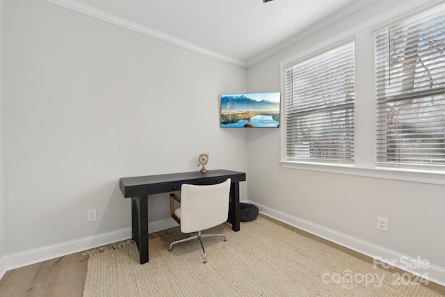 office with light wood-type flooring and ornamental molding