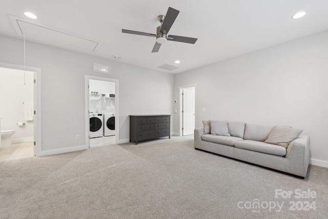 carpeted living room with washing machine and dryer and ceiling fan