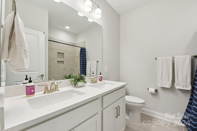 bathroom featuring curtained shower, tile patterned flooring, vanity, and toilet