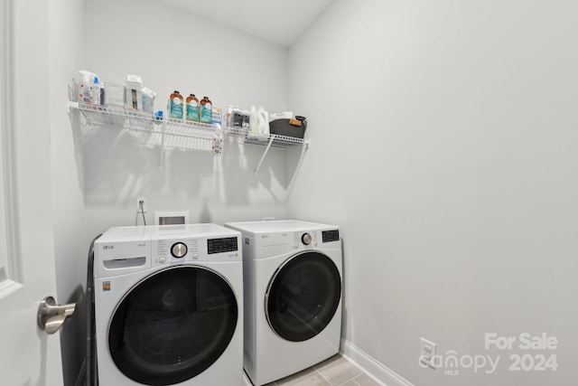 laundry room with light tile patterned floors and separate washer and dryer