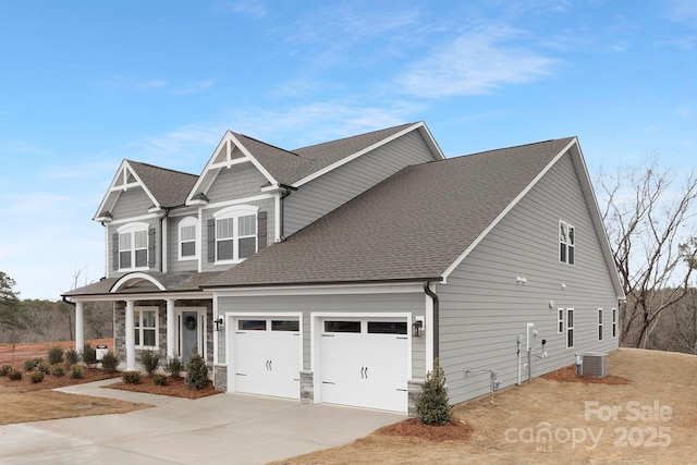 view of front facade with central AC unit and a garage