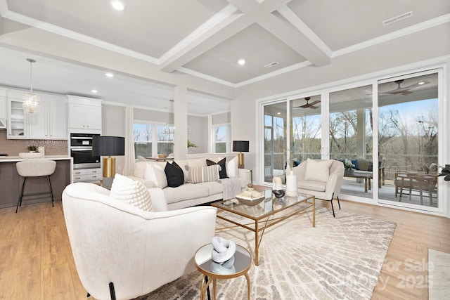 living room with crown molding, light hardwood / wood-style flooring, and beamed ceiling