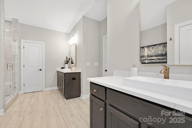 bathroom with vanity and a shower with door