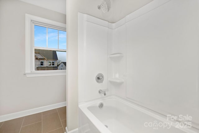 bathroom with tile patterned flooring and bathtub / shower combination