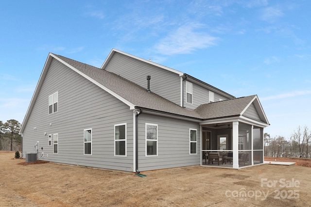 rear view of property featuring cooling unit, a lawn, and a sunroom