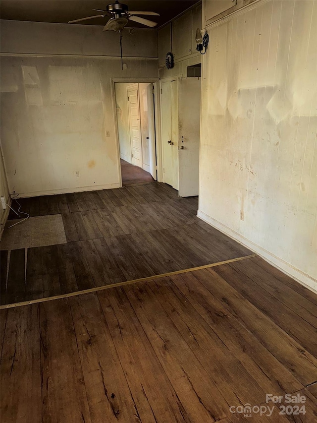 empty room featuring ceiling fan and dark hardwood / wood-style flooring