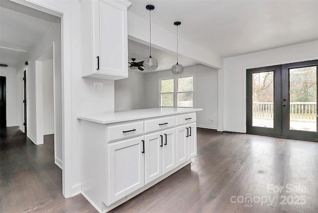 kitchen featuring hanging light fixtures, white cabinets, and french doors