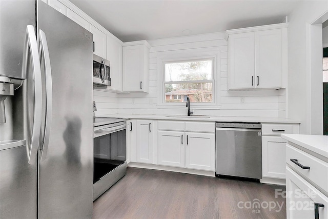 kitchen with white cabinets, appliances with stainless steel finishes, and sink