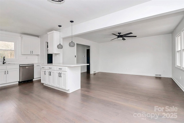 kitchen with white cabinetry, decorative light fixtures, dishwasher, a kitchen island, and sink