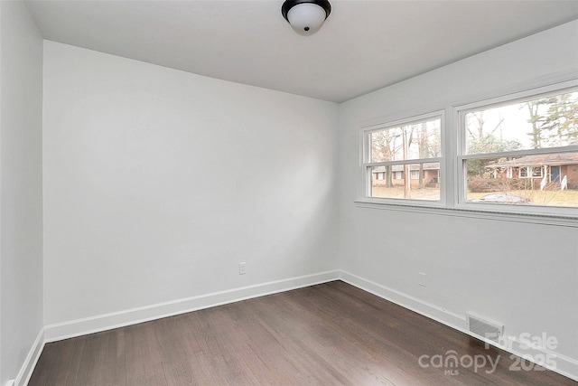 unfurnished room featuring dark hardwood / wood-style floors