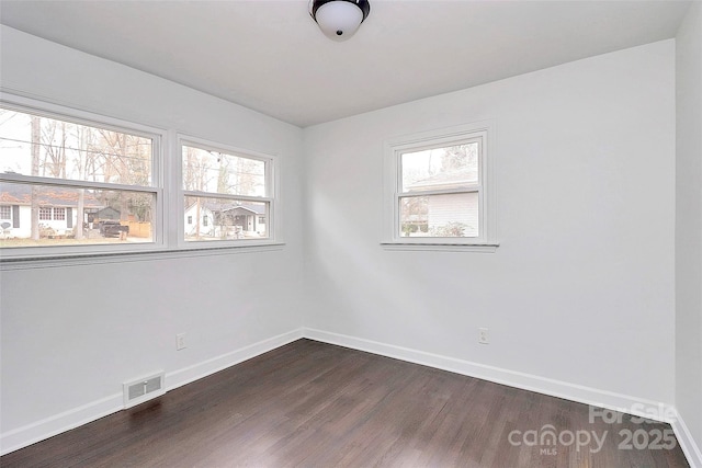 unfurnished room featuring dark wood-type flooring