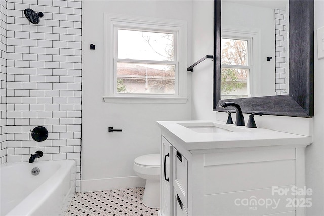 full bathroom with toilet, vanity, tile patterned flooring, and tiled shower / bath