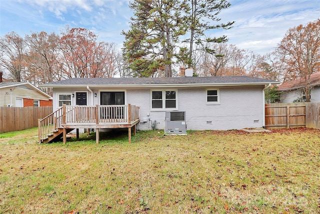 back of house featuring a deck and a lawn