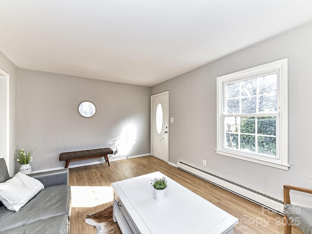 living room featuring hardwood / wood-style floors and baseboard heating