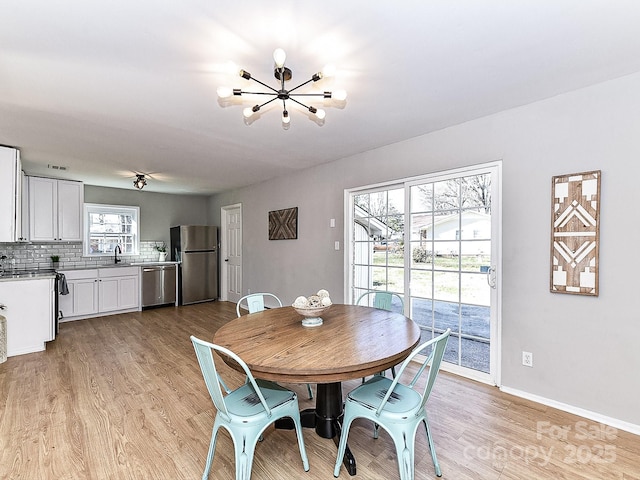 dining space featuring sink and light hardwood / wood-style floors