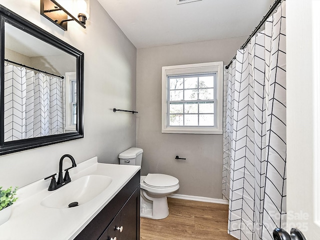 bathroom with a shower with shower curtain, vanity, toilet, and hardwood / wood-style floors