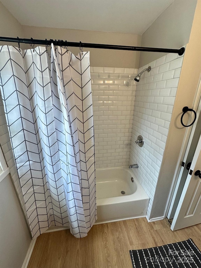 bathroom featuring hardwood / wood-style flooring and shower / bath combination with curtain