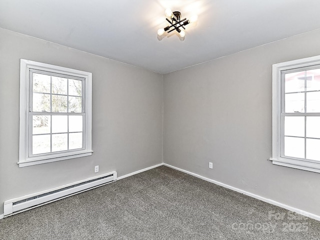 carpeted spare room with baseboard heating