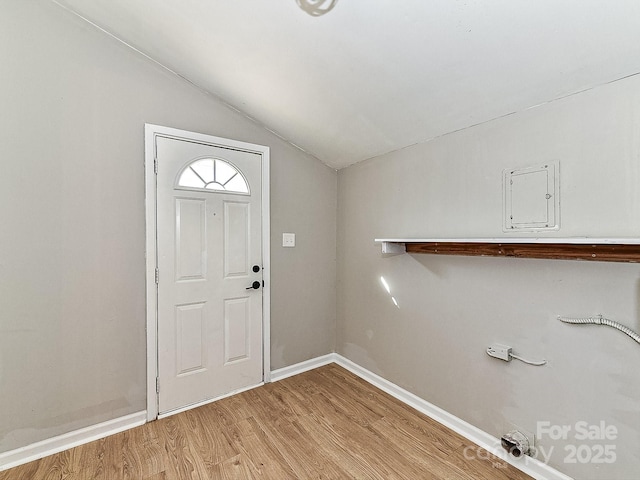 foyer entrance with vaulted ceiling and light hardwood / wood-style floors