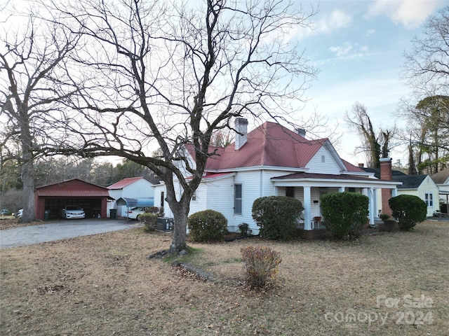 view of property exterior featuring an outdoor structure and a garage