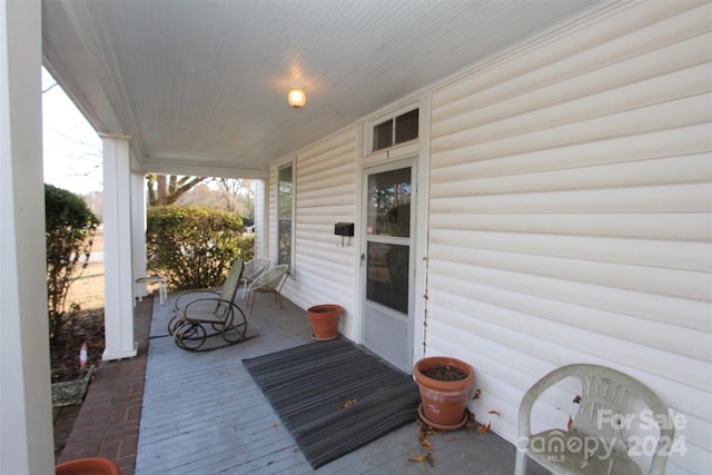 wooden terrace featuring covered porch