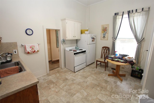 kitchen featuring white cabinetry, sink, crown molding, and white appliances