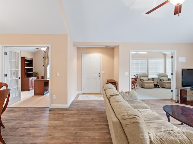 living room featuring ceiling fan, french doors, and light wood-type flooring