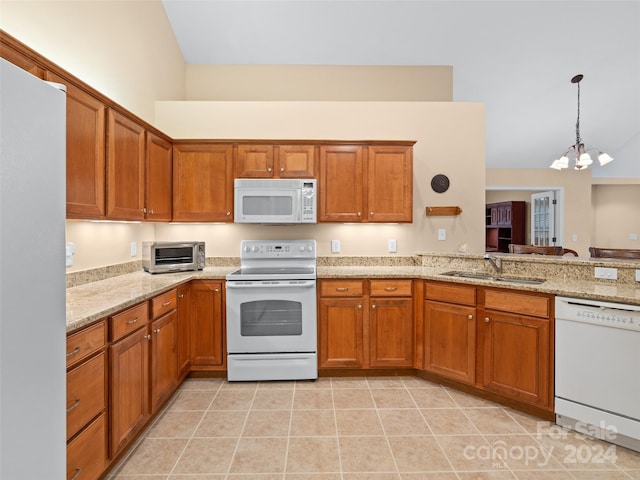 kitchen featuring sink, an inviting chandelier, lofted ceiling, decorative light fixtures, and white appliances