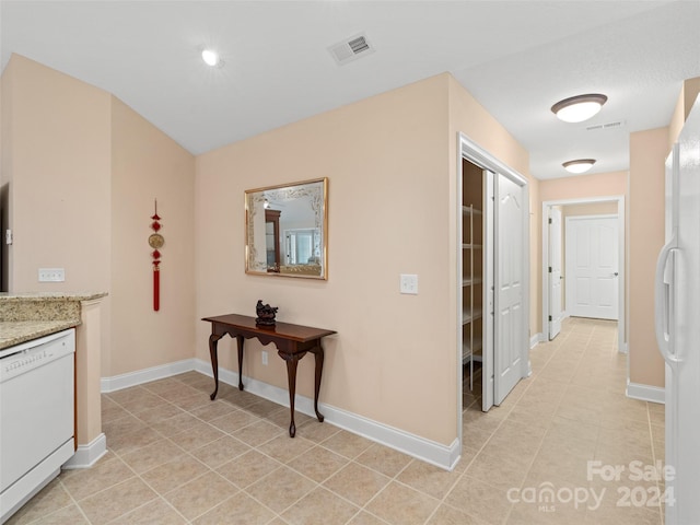 hall featuring light tile patterned flooring