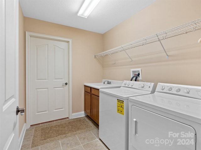 laundry room featuring cabinets, independent washer and dryer, sink, and light tile patterned flooring