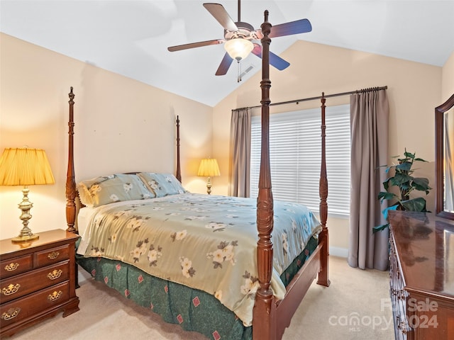 bedroom with light colored carpet, vaulted ceiling, and ceiling fan