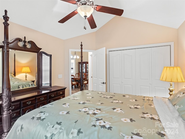 bedroom featuring a closet, ceiling fan with notable chandelier, and lofted ceiling