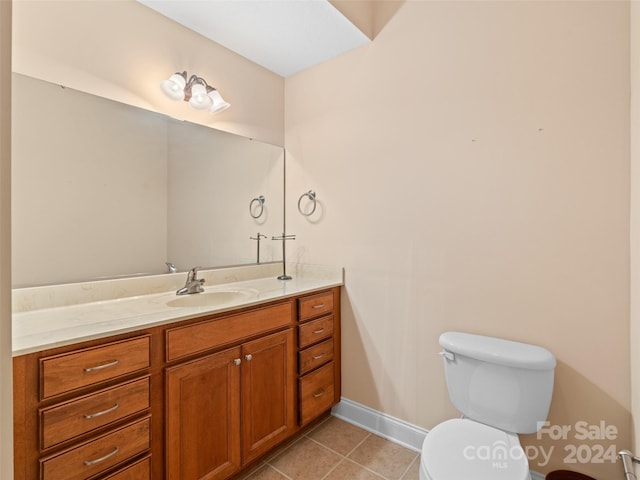 bathroom with tile patterned floors, vanity, and toilet