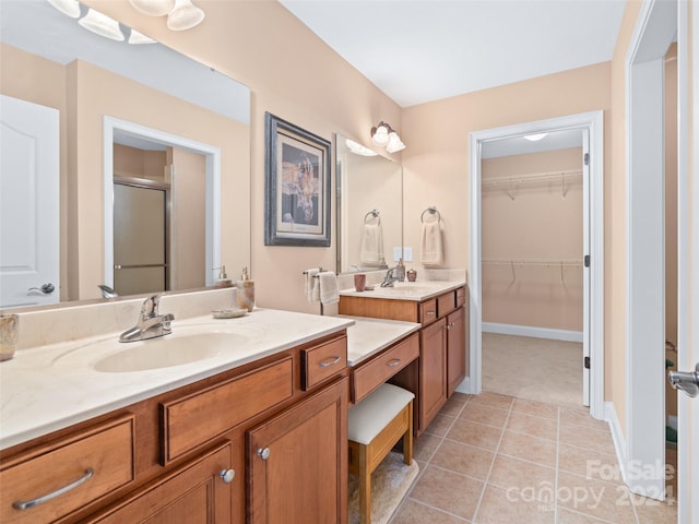 bathroom featuring tile patterned floors, vanity, and an enclosed shower