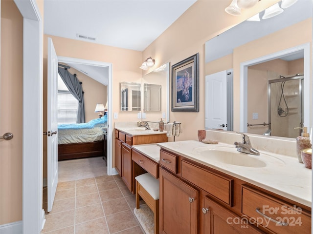 bathroom with vanity, tile patterned floors, and a shower with shower door