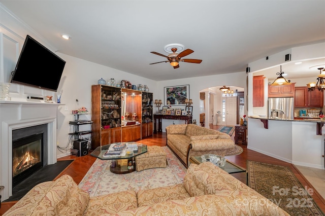 living room featuring dark hardwood / wood-style floors and ceiling fan