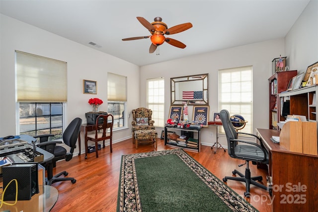 office with hardwood / wood-style flooring and ceiling fan