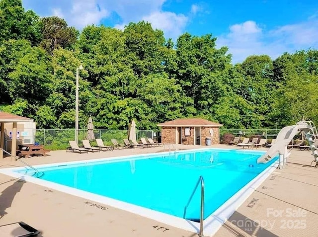 view of pool with an outdoor structure