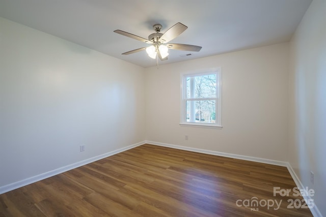 empty room featuring dark hardwood / wood-style floors and ceiling fan