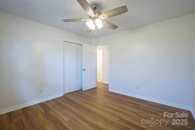 unfurnished bedroom with a closet, ceiling fan, and hardwood / wood-style flooring