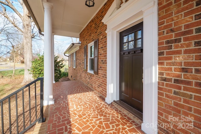 view of exterior entry with a porch