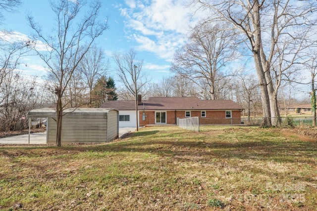 rear view of house featuring a yard