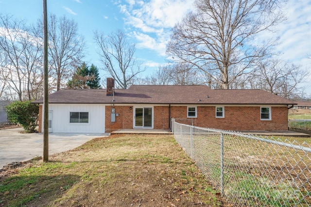 rear view of house featuring a yard and a patio