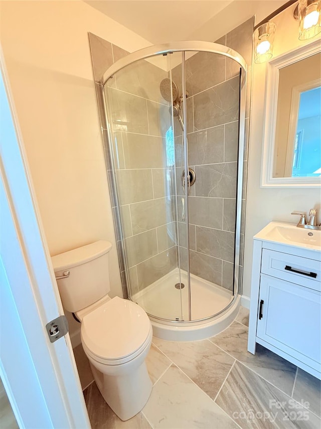 bathroom featuring vanity, toilet, and walk in shower