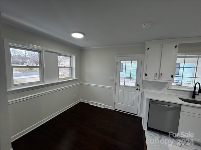 kitchen featuring tasteful backsplash, stainless steel dishwasher, sink, dark hardwood / wood-style floors, and white cabinetry