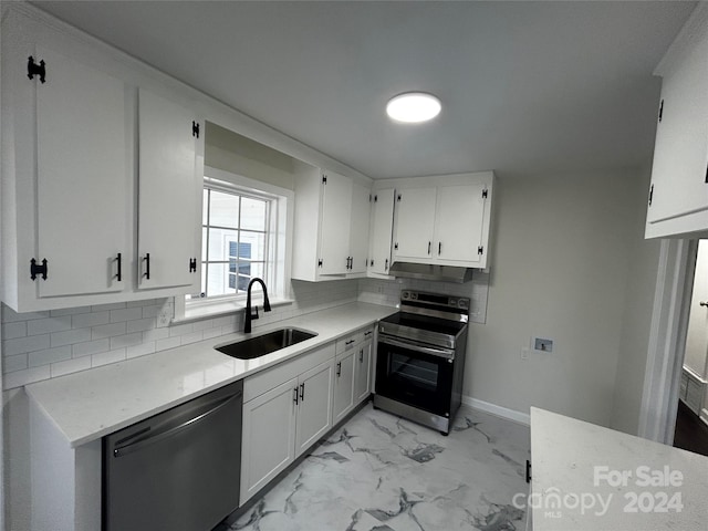 kitchen featuring tasteful backsplash, white cabinetry, sink, and appliances with stainless steel finishes