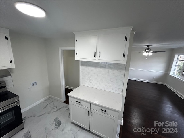 kitchen with white cabinetry, ceiling fan, light hardwood / wood-style floors, stainless steel range with electric stovetop, and decorative backsplash