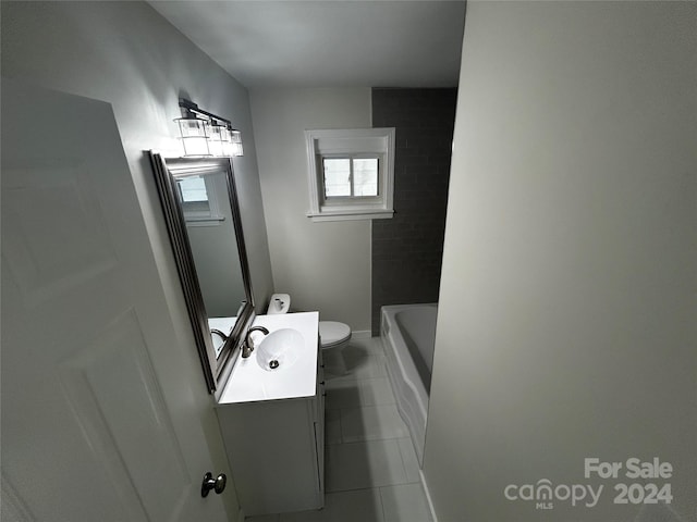 bathroom with toilet, vanity, and tile patterned floors