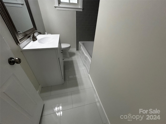 bathroom with tile patterned floors, vanity, and toilet