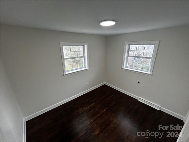 empty room with wood-type flooring and plenty of natural light